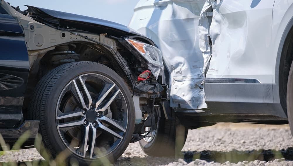 Cars crashed heavily in road accident after collision on city street.