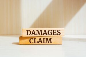 Damages & Claim written on Wooden Blocks