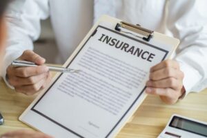 Loss Adjuster Insurance Agent pointing at document