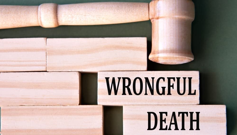 WRONGFUL DEATH - words on wooden blocks on a white background with a judge's gavel.