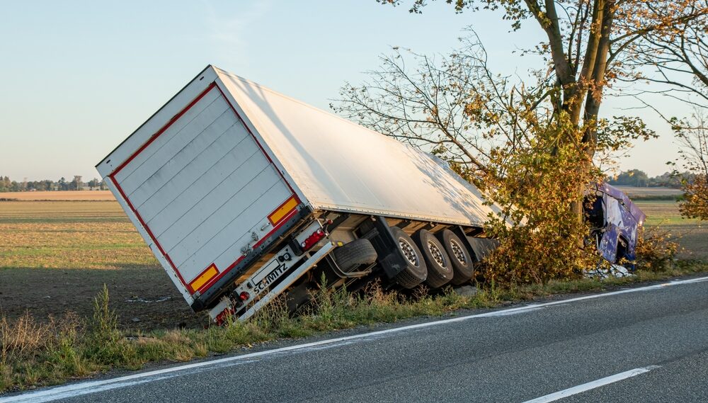 Truck accident. The car hit a tree. Load spilled in the field